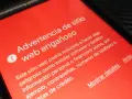 Alerta de advertencia en pantalla roja: "Advertencia de sitio web engañoso". Ayuda a comprobar web fraudulenta.