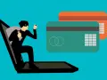 Ladrón sale de portátil con saco y linterna, cerca de tarjetas de crédito. Aprende como saber si una tienda online es falsa.