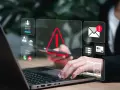 Alerta de seguridad digital: un mensaje falso podría estar acechando. Iconos de advertencia, correo, tarjetas y teléfonos flotan sobre un portátil.