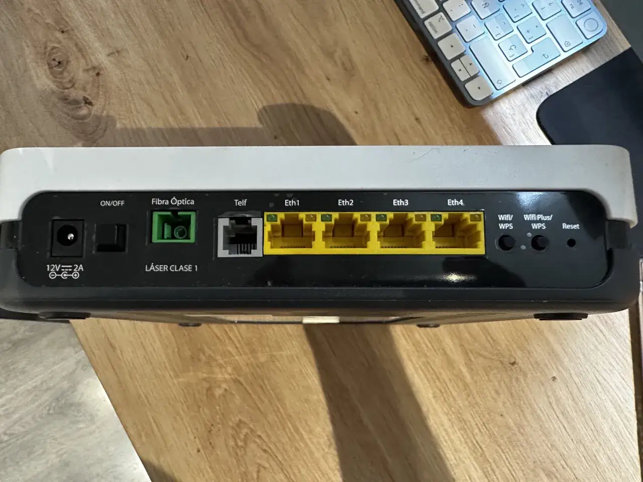 Conexiones de un ont router: puerto de alimentación, Fibra Óptica, Telf, cuatro puertos Ethernet amarillos, Wifi/WPS, Wifi Plus/WPS y Reset.