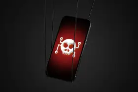 Un iPhone con un símbolo de calavera y tibias cruzadas en la pantalla, sugiriendo cómo saber si mi iPhone tiene un virus.
